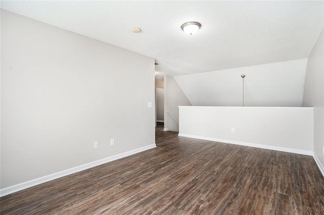 222 Ben Ln, Fairburn, GA 30213 - additional living space featuring dark wood-type flooring, baseboards, and vaulted ceiling