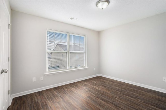 222 Ben Ln, Fairburn, GA 30213 - spare room featuring dark wood-style floors and baseboards