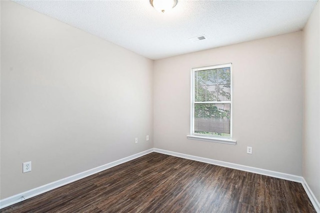 222 Ben Ln, Fairburn, GA 30213 - empty room featuring dark wood-style floors, baseboards, and a textured ceiling