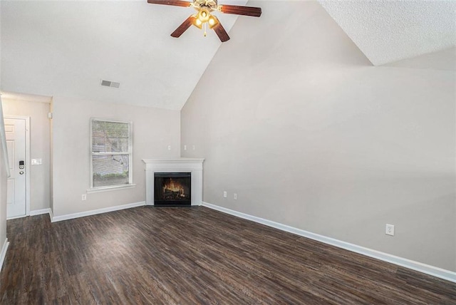 222 Ben Ln, Fairburn, GA 30213 - unfurnished living room with a ceiling fan, dark wood finished floors, a warm lit fireplace, baseboards, and high vaulted ceiling