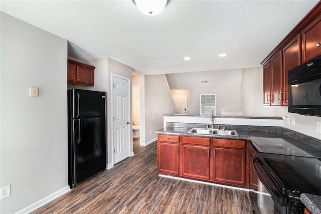 222 Ben Ln, Fairburn, GA 30213 - kitchen with black appliances, a sink, a peninsula, dark wood-style flooring, and reddish brown cabinets