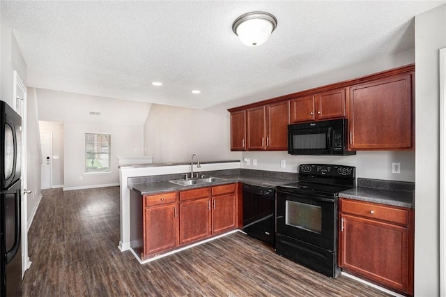 222 Ben Ln, Fairburn, GA 30213 - kitchen with black appliances, a sink, a peninsula, dark countertops, and dark wood-style flooring