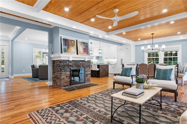 1658 E Clifton Rd NE, Atlanta, GA 30307 - living room with a wooden ceiling with exposed beams, light wood-style floors, a ceiling fan, a brick fireplace, and recessed lighting