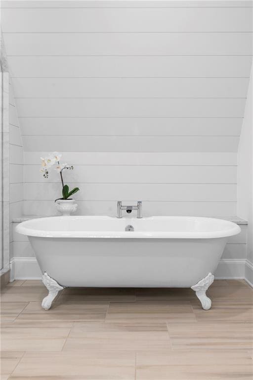 1658 E Clifton Rd NE, Atlanta, GA 30307 - bathroom with wood finished floors, a freestanding tub, and wooden walls