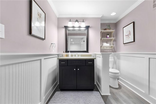 1658 E Clifton Rd NE, Atlanta, GA 30307 - bathroom featuring a decorative wall, a wainscoted wall, vanity, crown molding, and wood finished floors