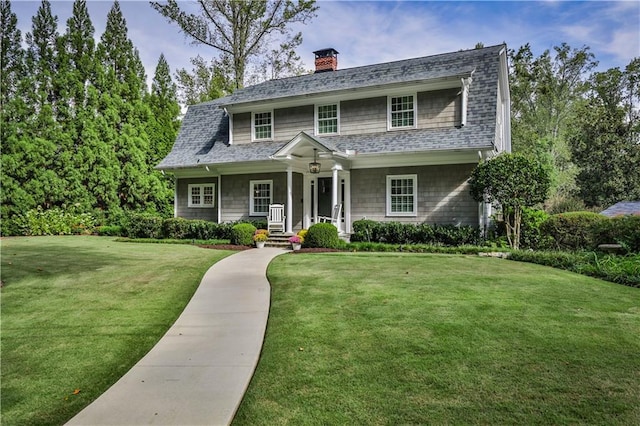 1658 E Clifton Rd NE, Atlanta, GA 30307 - view of front facade with a front lawn, a chimney, roof with shingles, and a porch