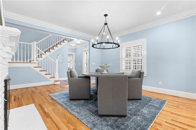 1658 E Clifton Rd NE, Atlanta, GA 30307 - dining space with a chandelier, stairs, wood finished floors, and crown molding