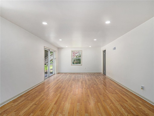 unfurnished room featuring recessed lighting, visible vents, and light wood finished floors