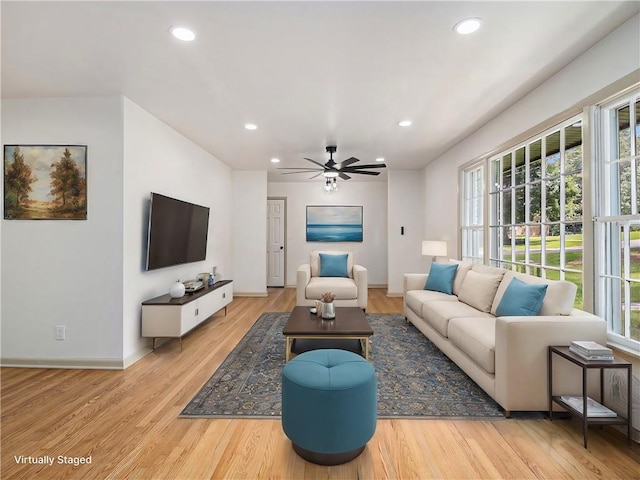 living area featuring recessed lighting, a ceiling fan, baseboards, and wood finished floors