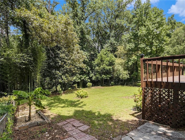 view of yard with a deck and a garden