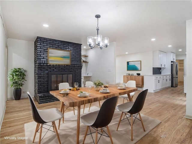 dining room with a chandelier, recessed lighting, and light wood-style flooring