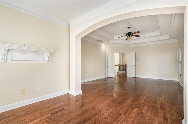 unfurnished living room with dark hardwood / wood-style floors, ceiling fan, ornamental molding, and a raised ceiling