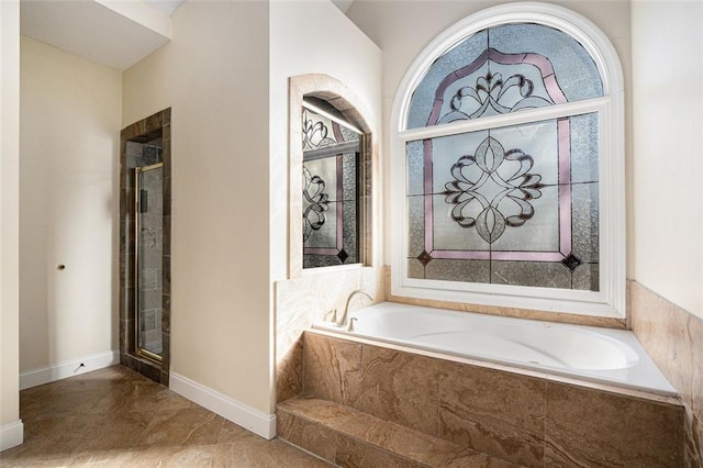 bathroom featuring independent shower and bath