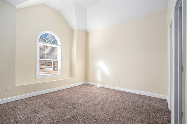 unfurnished room featuring lofted ceiling and carpet floors