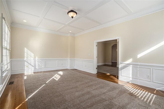 unfurnished room with beam ceiling, dark wood-type flooring, coffered ceiling, and ornamental molding