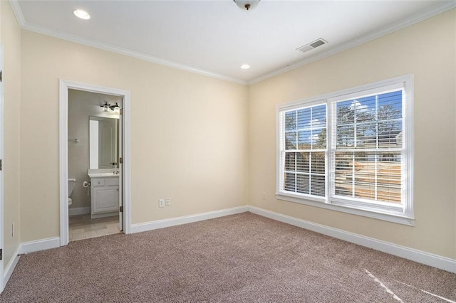 carpeted spare room featuring ornamental molding