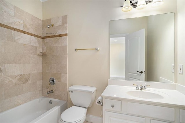 full bathroom featuring toilet, tiled shower / bath, and vanity