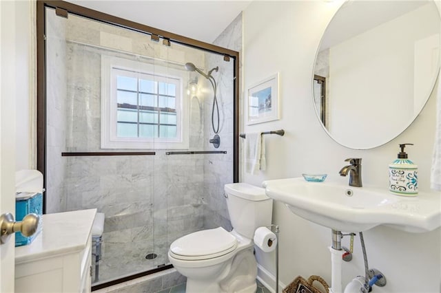 bathroom with toilet, walk in shower, and sink