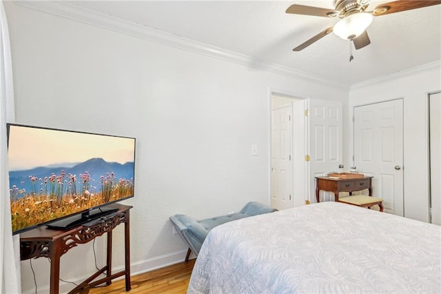 bedroom with ceiling fan, ornamental molding, and wood-type flooring