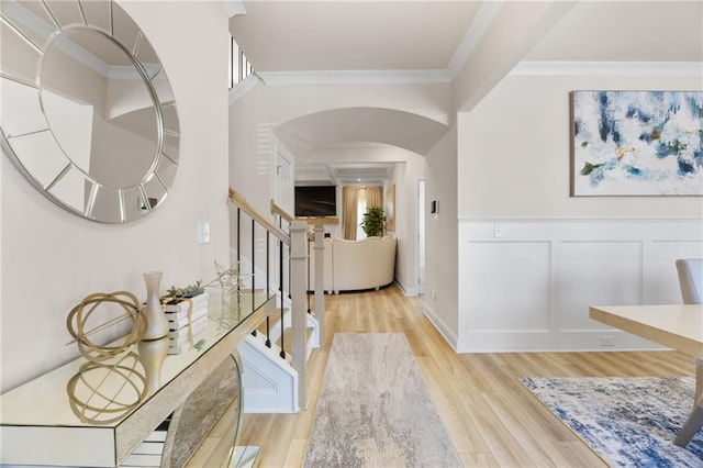 entryway featuring crown molding and light wood-type flooring