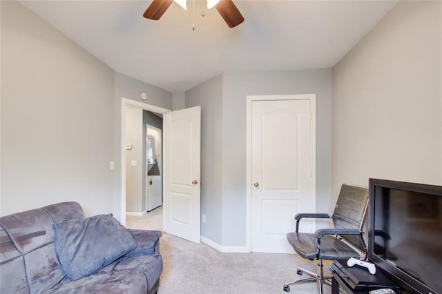 office space featuring light carpet, ceiling fan, and baseboards