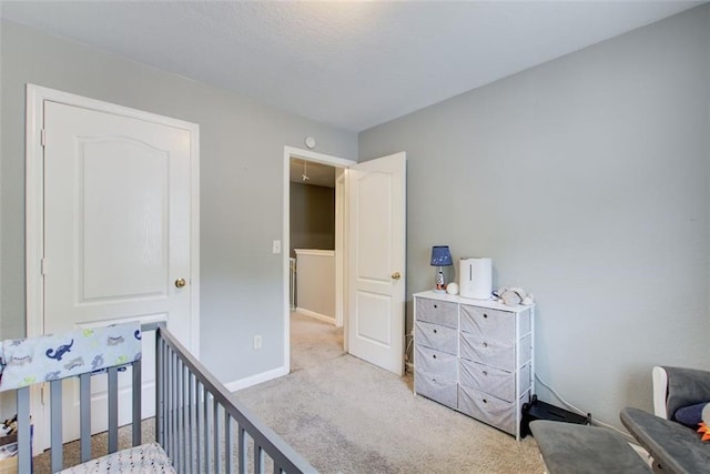 carpeted bedroom featuring baseboards