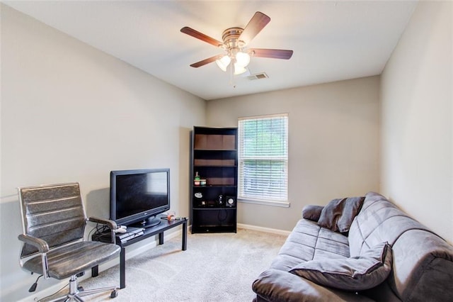 carpeted living room with visible vents, baseboards, and a ceiling fan