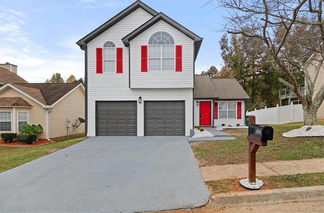 view of property featuring a garage and a front yard