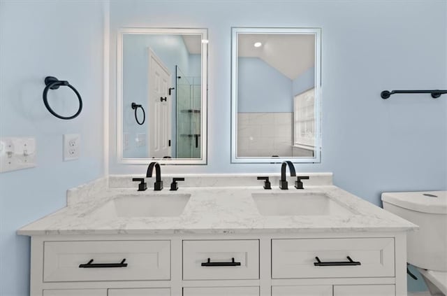 bathroom featuring toilet, vanity, vaulted ceiling, and walk in shower