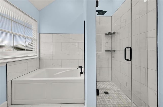 bathroom featuring tile patterned flooring, plus walk in shower, and tile walls