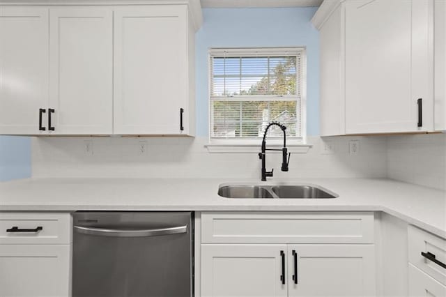 kitchen featuring dishwasher, tasteful backsplash, white cabinets, and sink