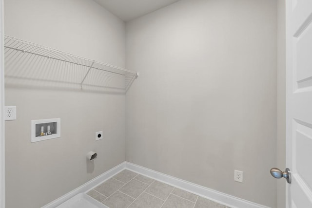 laundry area with laundry area, light tile patterned floors, hookup for a washing machine, hookup for an electric dryer, and baseboards