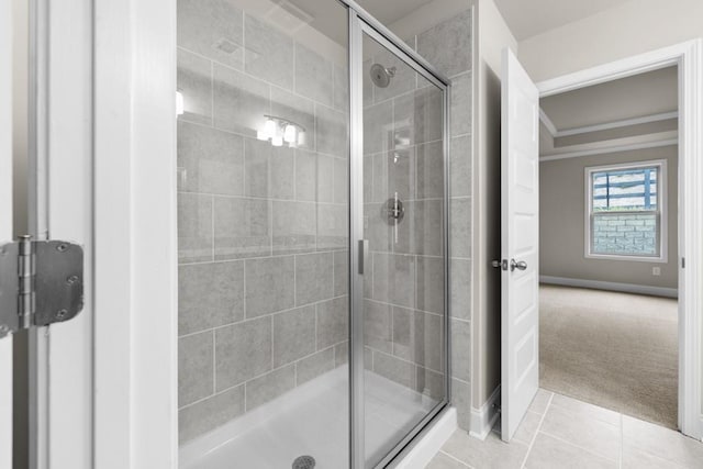bathroom with a shower stall, tile patterned floors, and baseboards