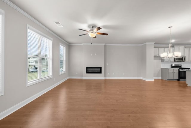 unfurnished living room featuring visible vents, light wood-type flooring, a glass covered fireplace, and ceiling fan with notable chandelier