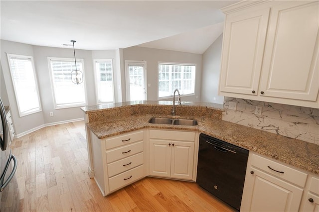 1200 Martins Chapel Ln SE, Lawrenceville, GA 30045 - kitchen featuring dishwasher, a peninsula, light wood-style floors, light stone countertops, and lofted ceiling