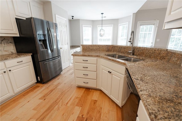 1200 Martins Chapel Ln SE, Lawrenceville, GA 30045 - kitchen with stainless steel refrigerator with ice dispenser, black dishwasher, light wood-style floors, light stone counters, and white cabinets