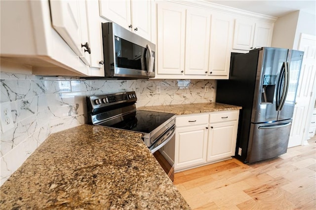 1200 Martins Chapel Ln SE, Lawrenceville, GA 30045 - kitchen with stainless steel appliances, white cabinetry, tasteful backsplash, and dark stone countertops