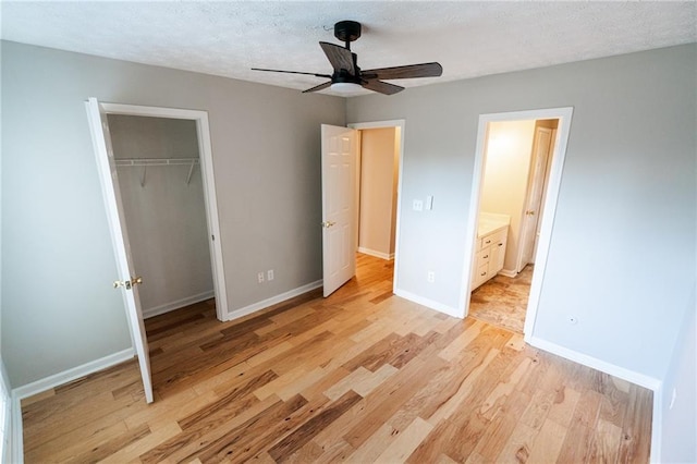 1200 Martins Chapel Ln SE, Lawrenceville, GA 30045 - unfurnished bedroom featuring light wood-type flooring, a closet, a textured ceiling, a ceiling fan, and ensuite bathroom