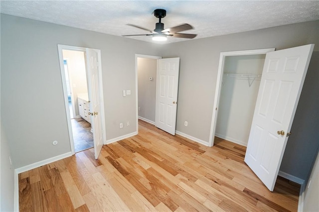 1200 Martins Chapel Ln SE, Lawrenceville, GA 30045 - unfurnished bedroom featuring light wood-type flooring, a closet, a textured ceiling, and a ceiling fan