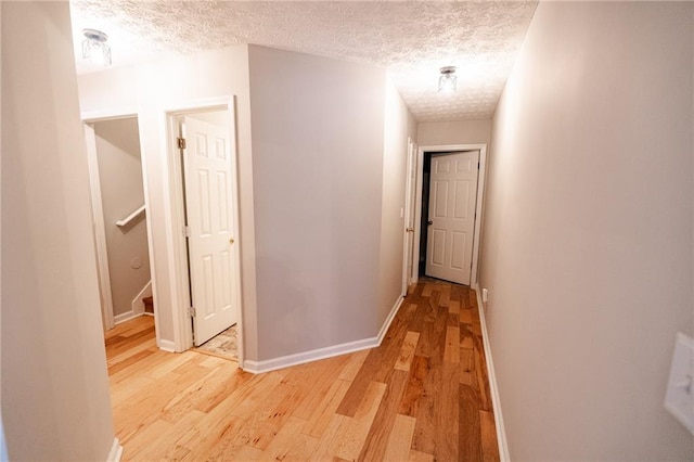 1200 Martins Chapel Ln SE, Lawrenceville, GA 30045 - corridor with light wood-style flooring and a textured ceiling