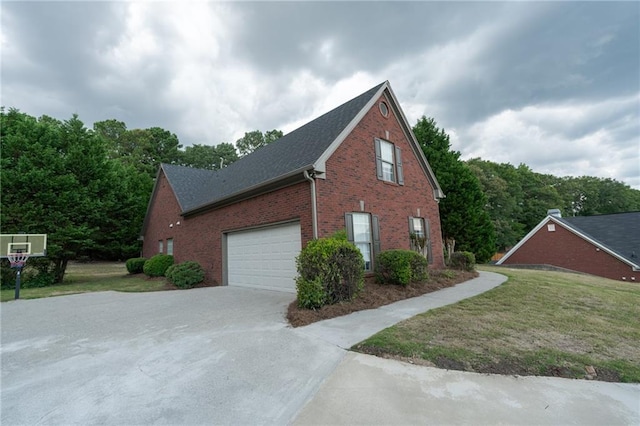 1200 Martins Chapel Ln SE, Lawrenceville, GA 30045 - view of side of property featuring brick siding, a garage, driveway, and a lawn