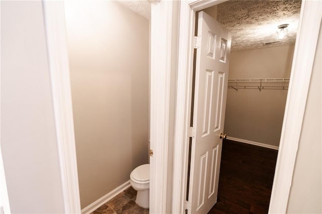 1200 Martins Chapel Ln SE, Lawrenceville, GA 30045 - bathroom featuring a textured ceiling and a walk in closet
