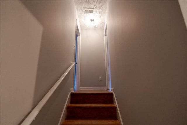 1200 Martins Chapel Ln SE, Lawrenceville, GA 30045 - staircase featuring a textured ceiling