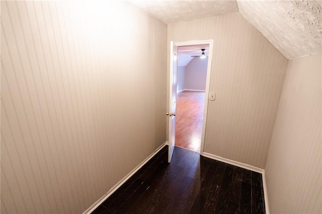 1200 Martins Chapel Ln SE, Lawrenceville, GA 30045 - hall with vaulted ceiling, dark wood-style flooring, a textured ceiling, and wood walls