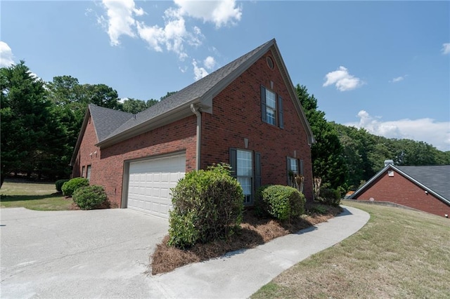 1200 Martins Chapel Ln SE, Lawrenceville, GA 30045 - view of home's exterior with brick siding, driveway, a garage, and a yard