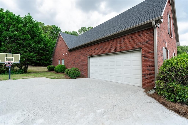 1200 Martins Chapel Ln SE, Lawrenceville, GA 30045 - view of property exterior with driveway, a shingled roof, and brick siding