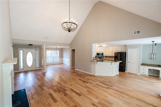 1200 Martins Chapel Ln SE, Lawrenceville, GA 30045 - kitchen featuring black fridge, high vaulted ceiling, open floor plan, a chandelier, and stainless steel microwave