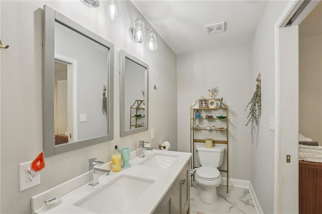bathroom featuring a sink, visible vents, toilet, and marble finish floor
