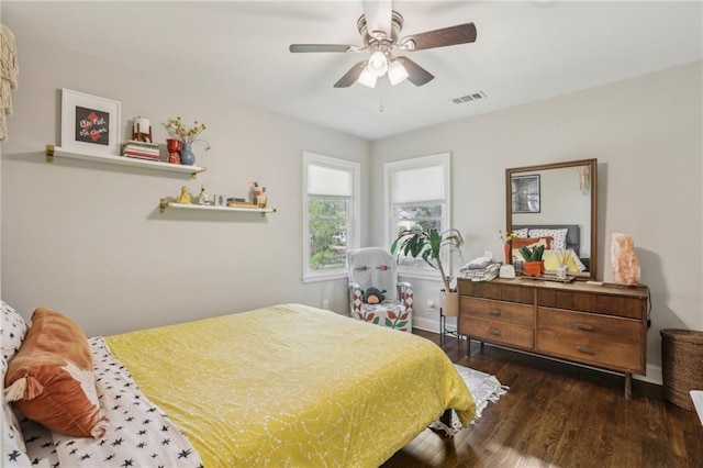 bedroom with visible vents, ceiling fan, and wood finished floors