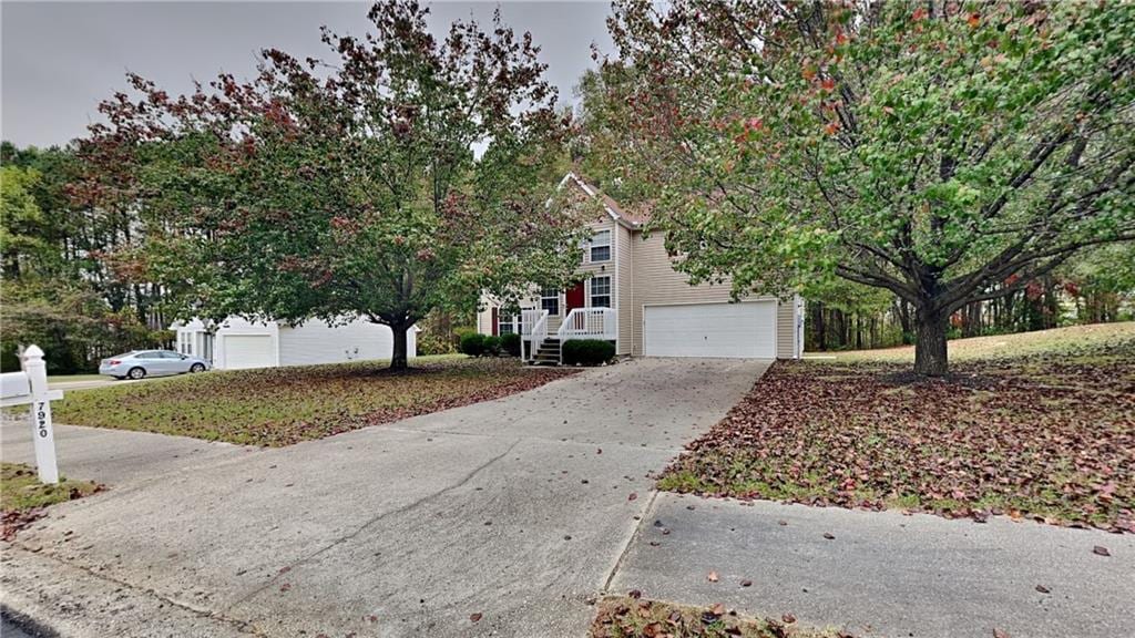 obstructed view of property with a garage